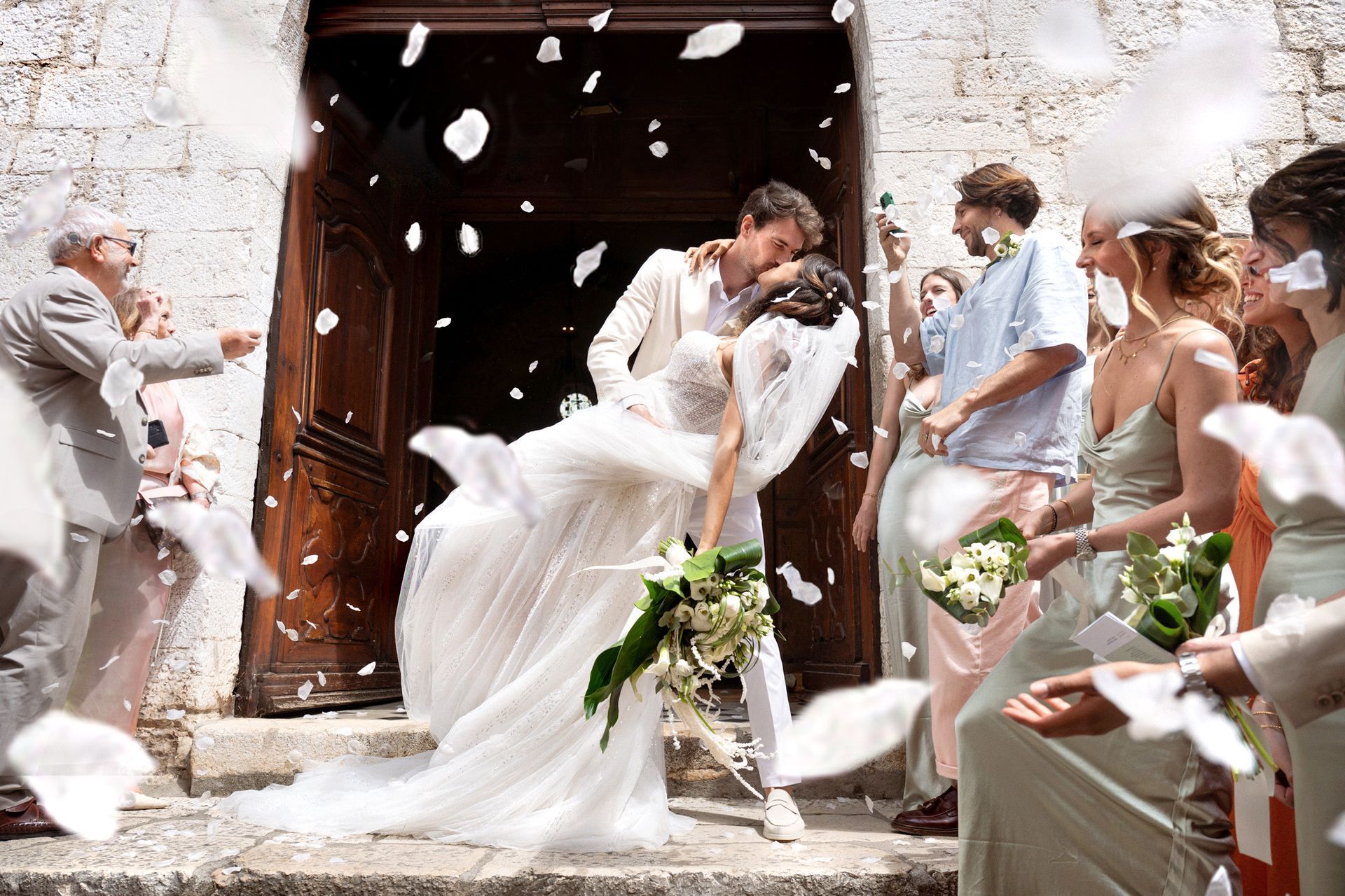 A couple showered with confetti after their wedding in the South of France.