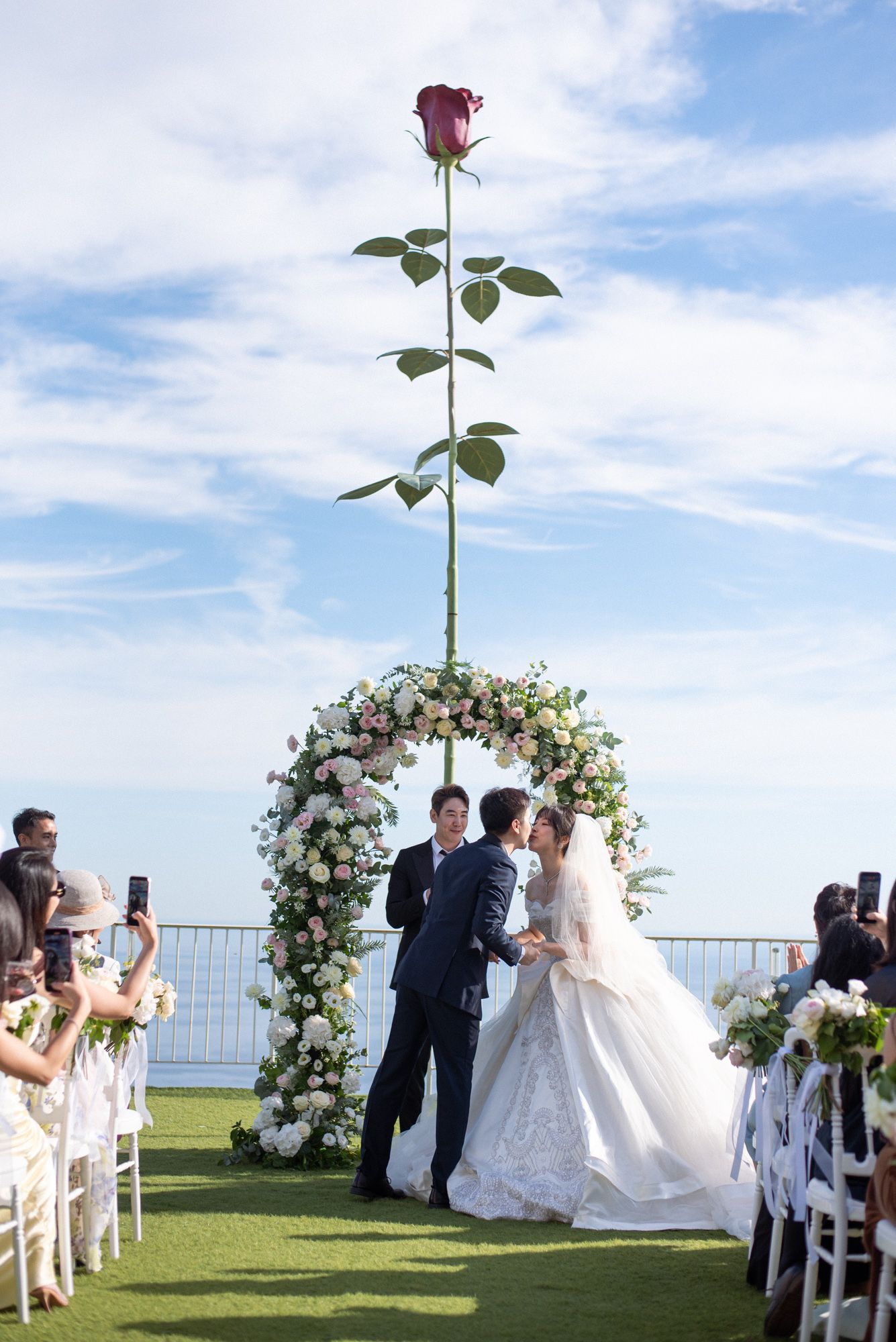 A first kiss at a wedding ceremony on the Rose Terrace at the Chevre d'Or Hotel
