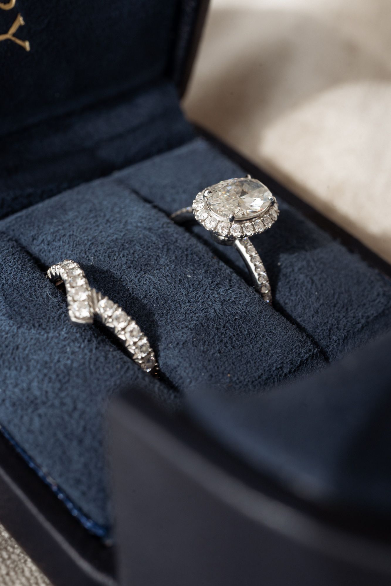 Two diamond wedding rings lit by soft white light