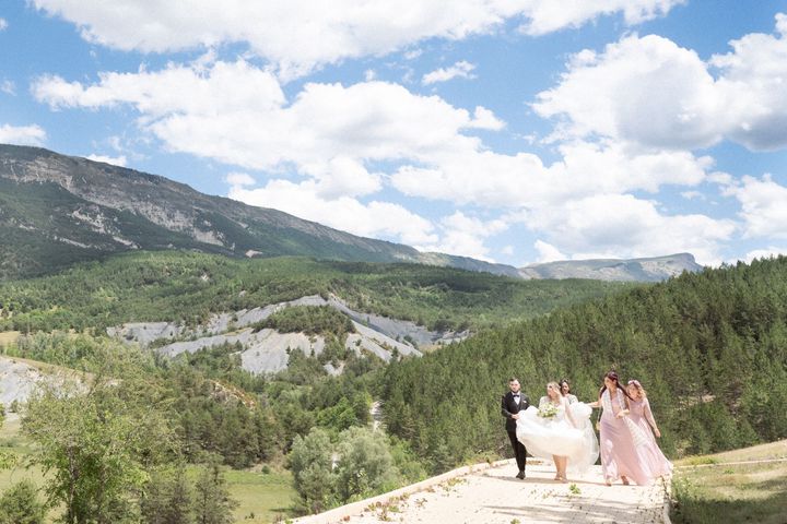 A bride walking through the mountains during a French Alps wedding.