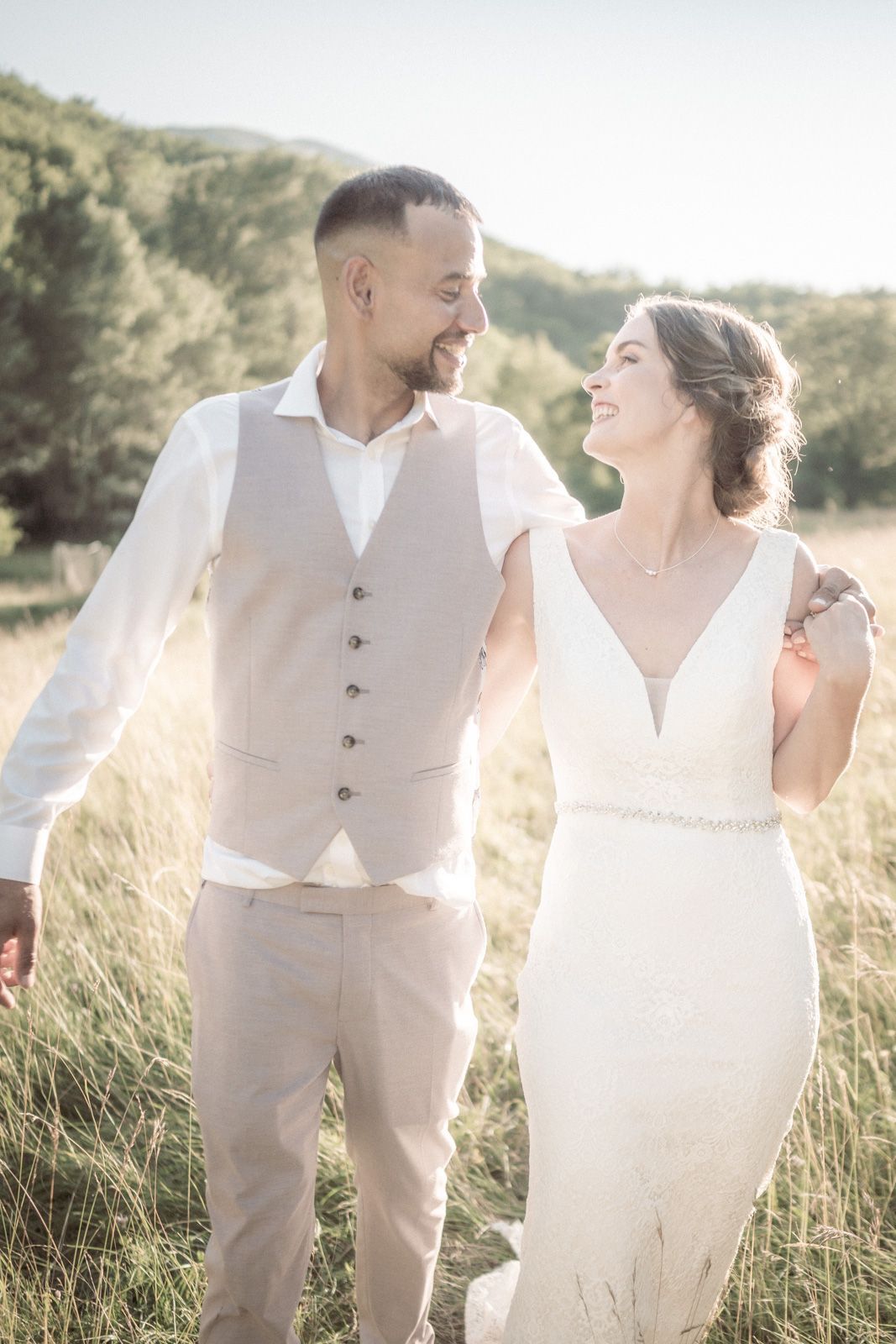 A couple laugh and smile during sunset at their wedding in the South of France.