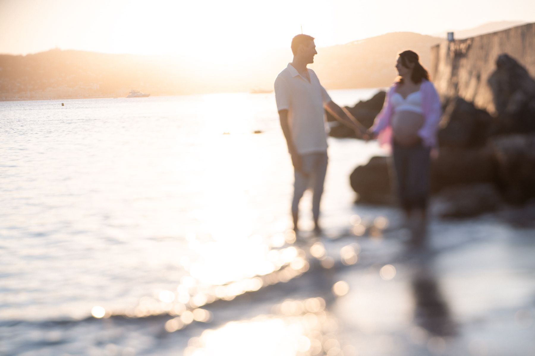 A hazy image of a silhouetted couple during a maternity photoshoot in the south of France.