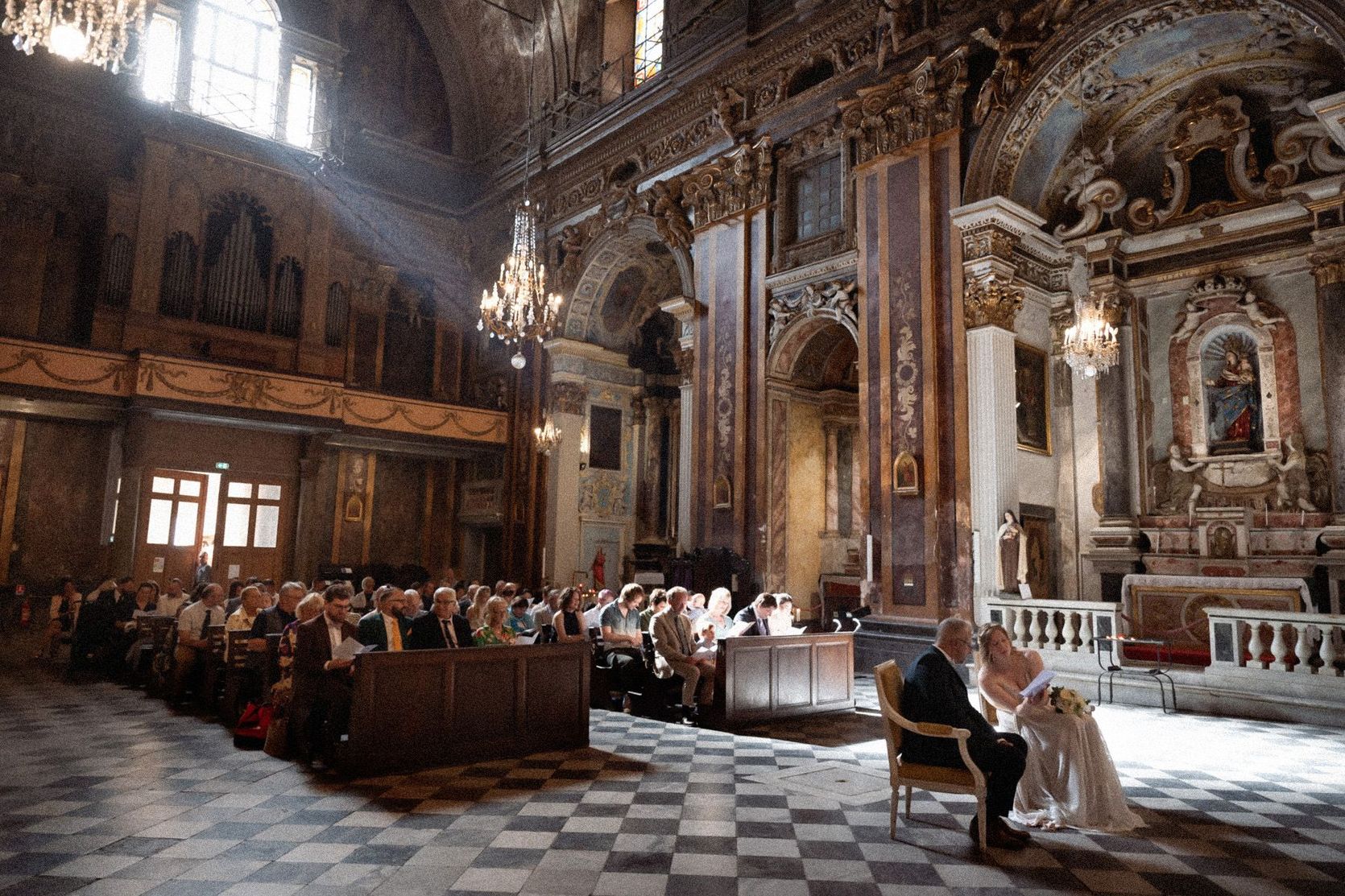 The interior of the Saint Jacques le Majeur church in Nice during a wedding ceremony.