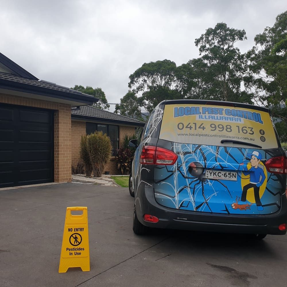A Blue Car Is Parked In Front Of A House — Local Pest Control Illawarra in Horsley, NSW