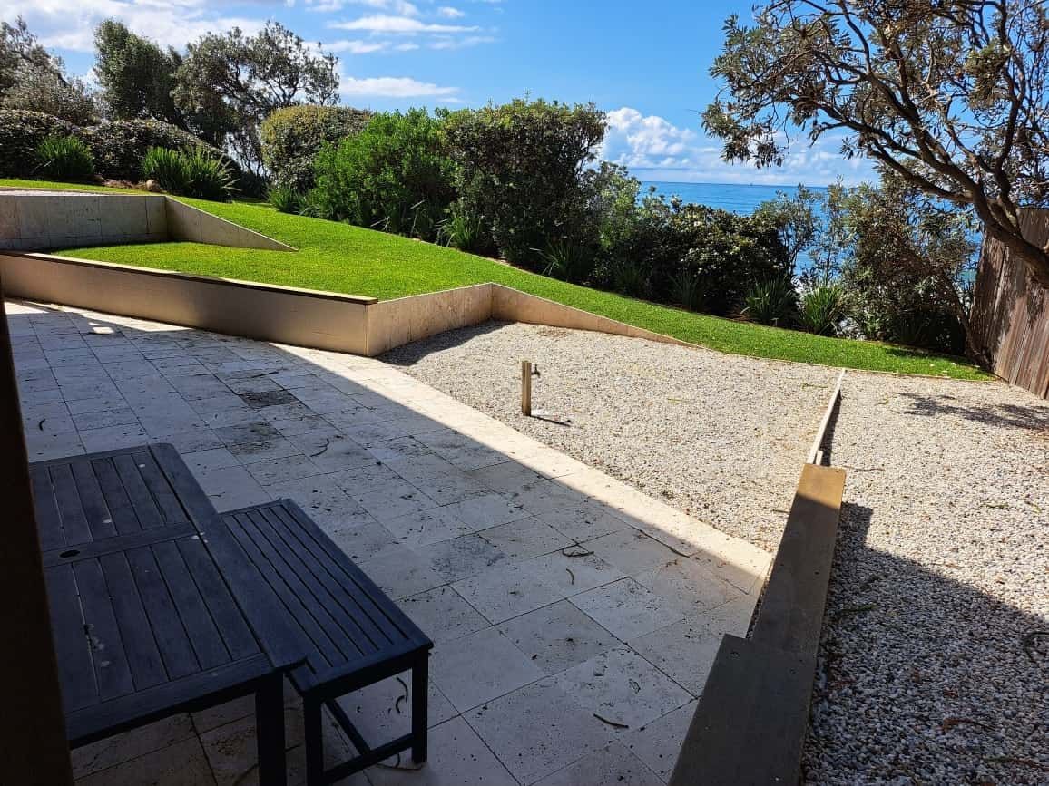 A Patio With A Table And Chairs And A View Of The Ocean — Local Pest Control Illawarra in Kiama, NSW