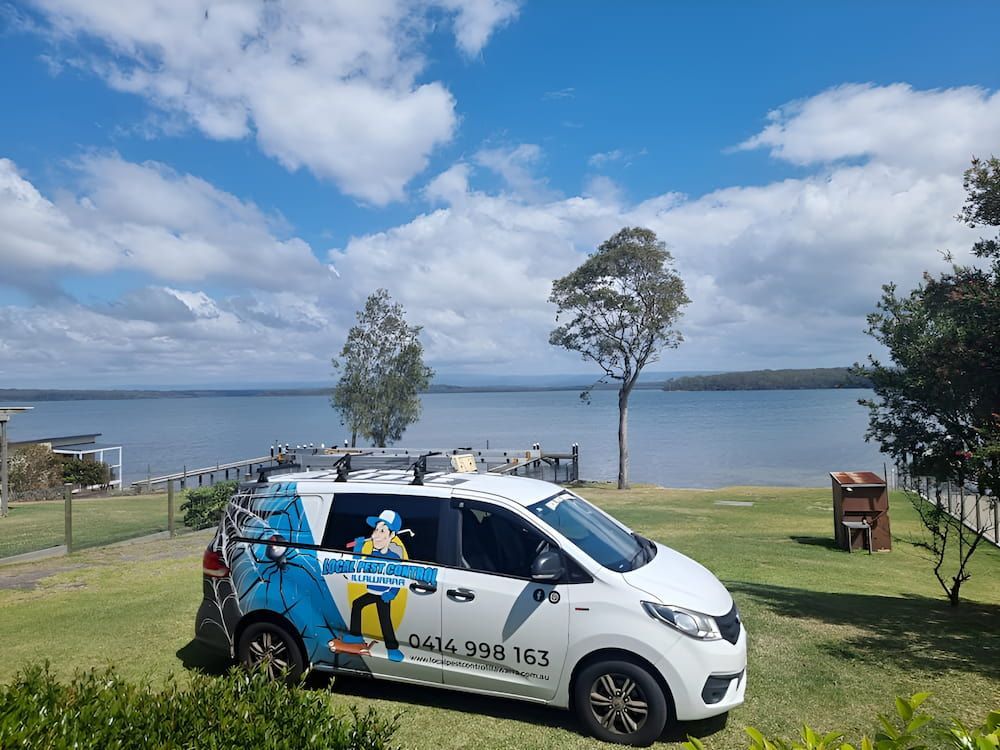 A White Van Is Parked In Front Of A Body Of Water — Local Pest Control Illawarra in Horsley, NSW