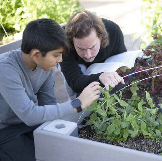 Montessori teacher and student working outside