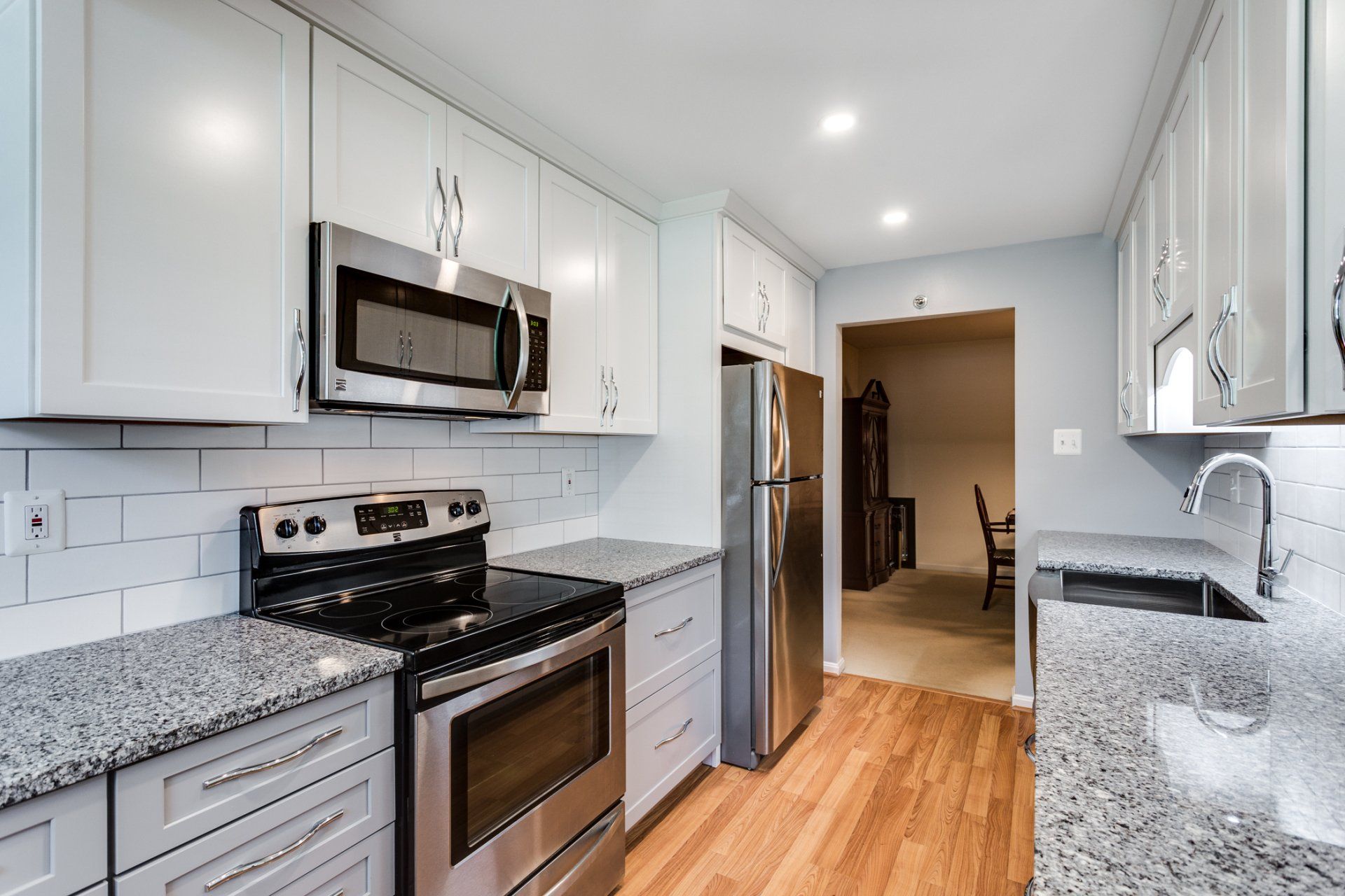 A kitchen with stainless steel appliances and granite counter tops