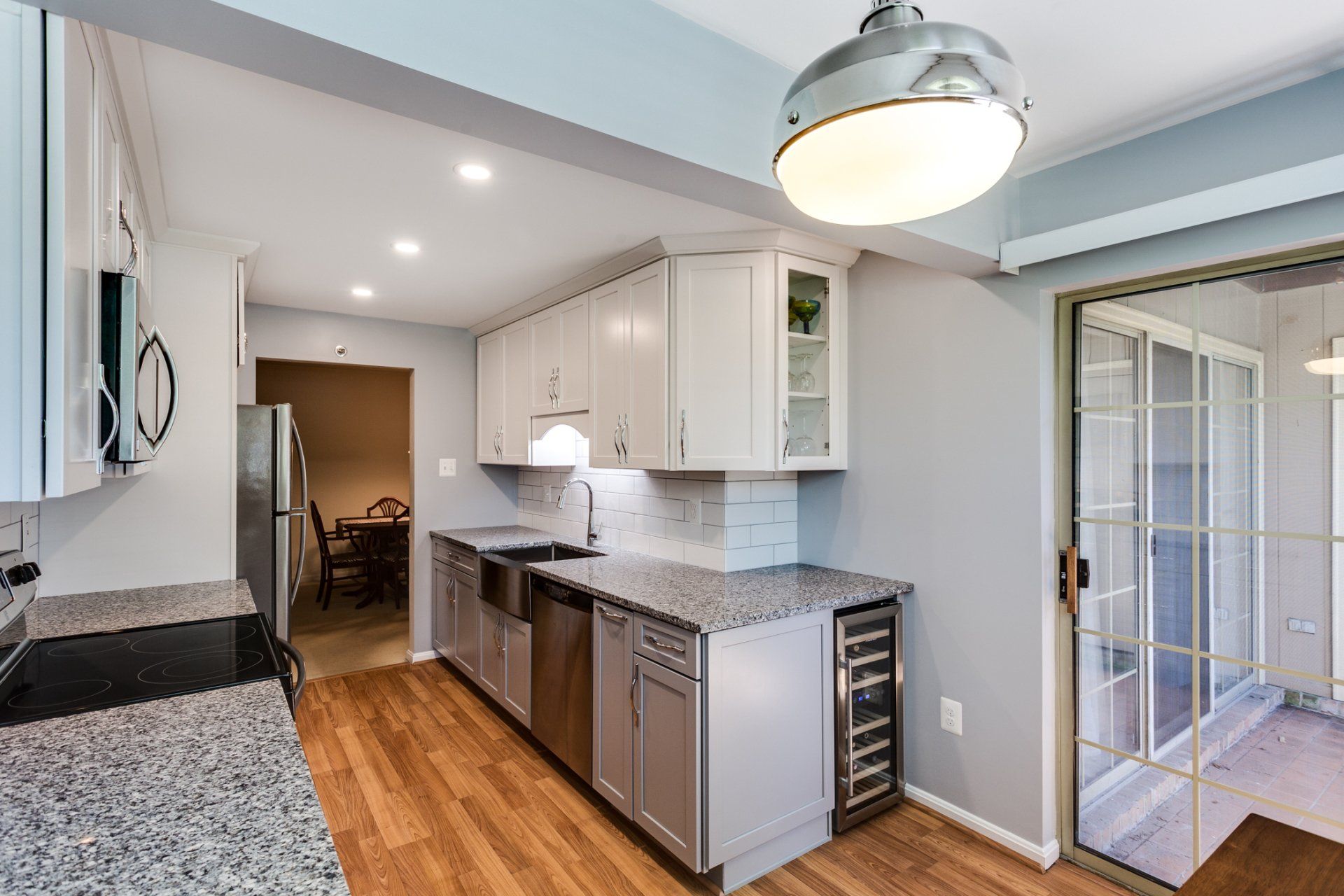 A kitchen with granite counter tops and stainless steel appliances.