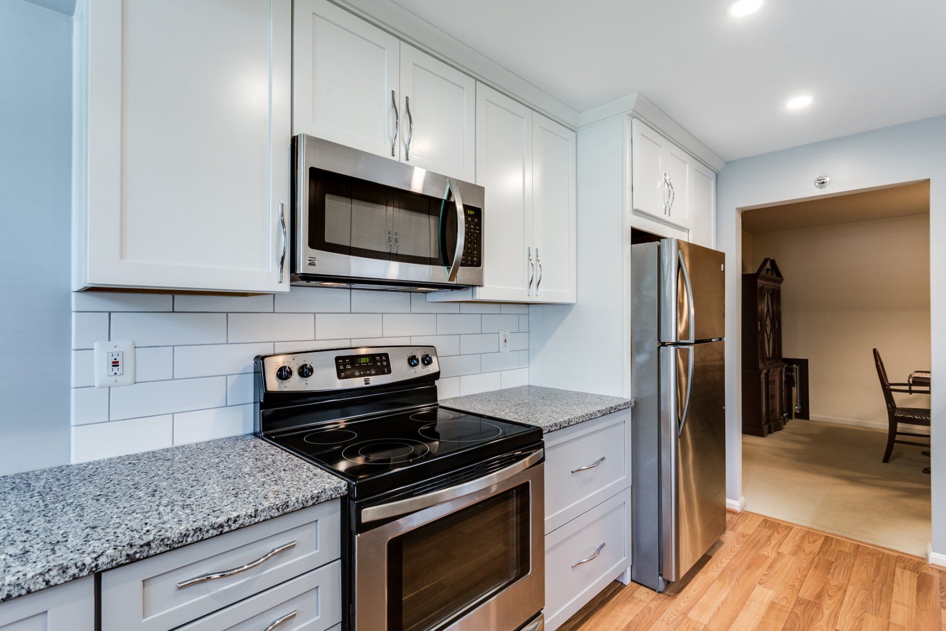 A kitchen with stainless steel appliances and granite counter tops