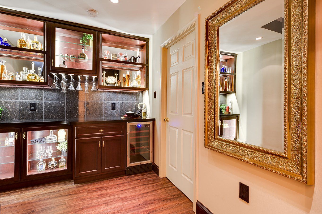 A room with a bar and a mirror on the wall.