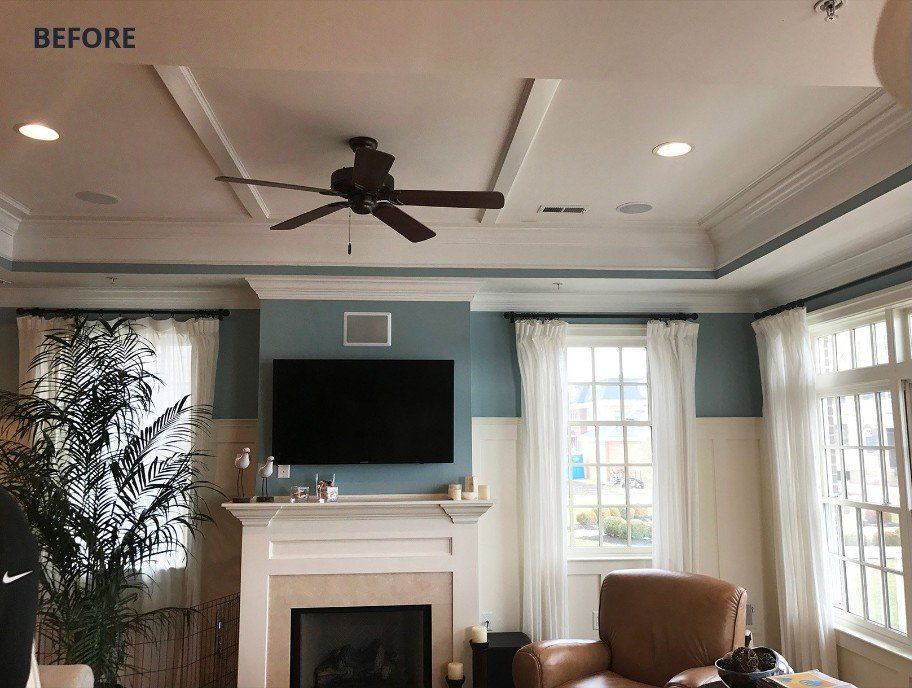 A living room with a fireplace and a flat screen tv.