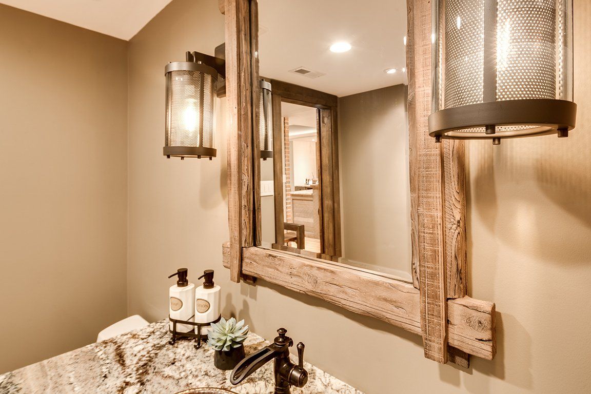 A bathroom with a large mirror and a sink.