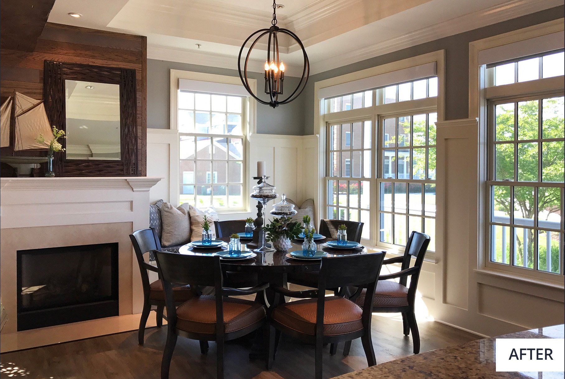 A dining room with a table and chairs and a fireplace.