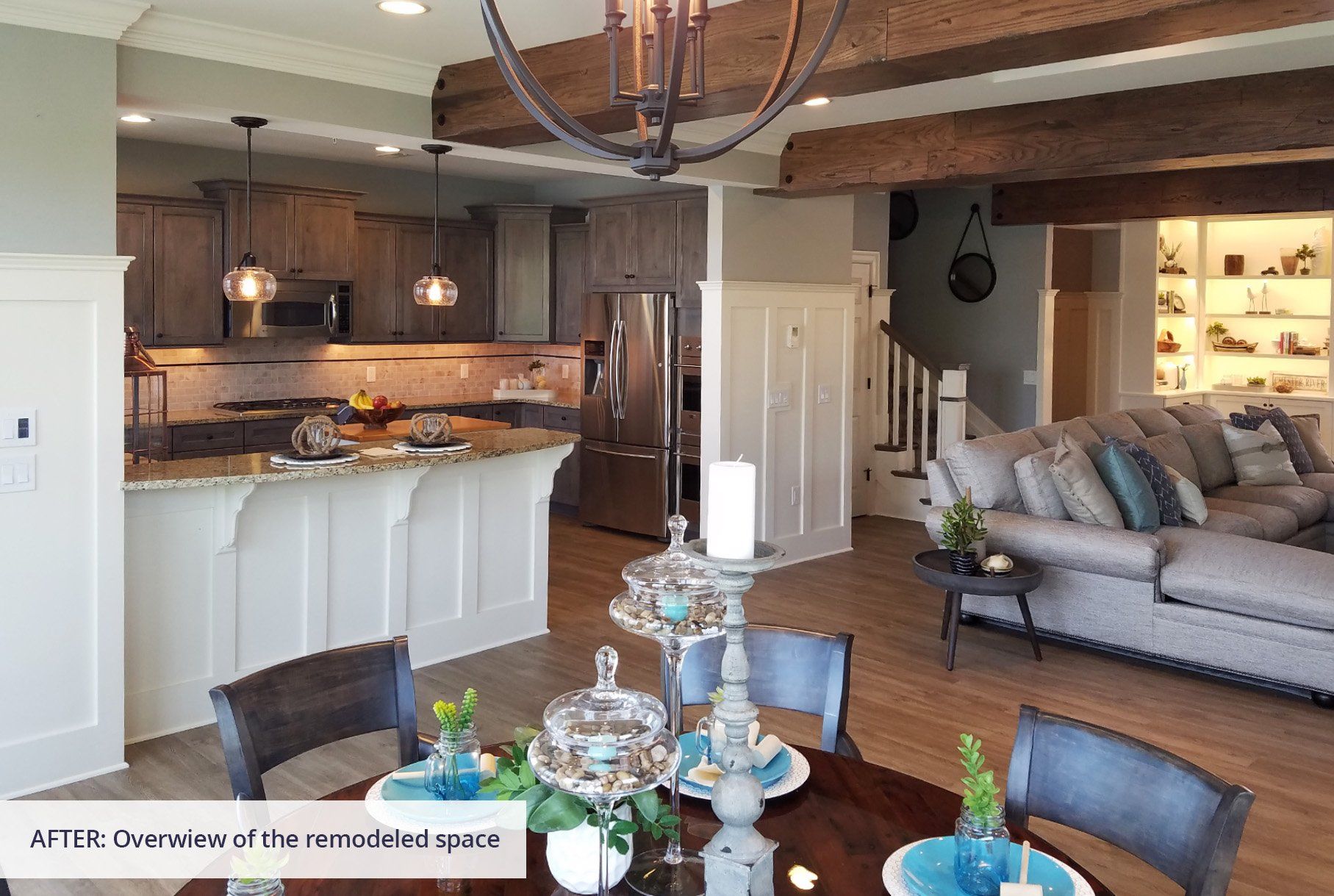 A living room with a dining table and chairs and a kitchen.