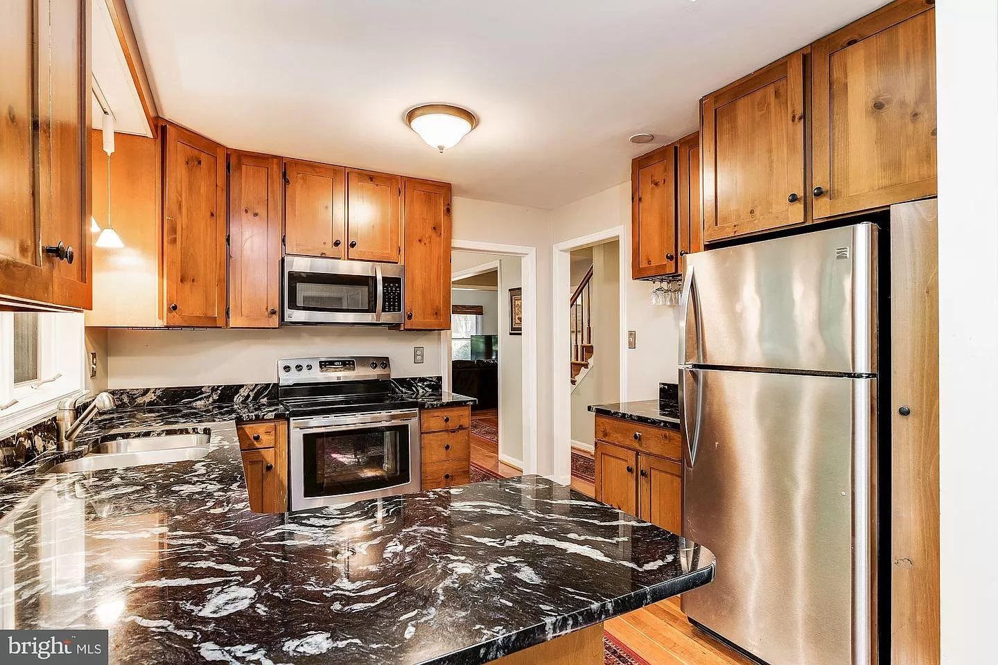 A kitchen with stainless steel appliances and granite counter tops.