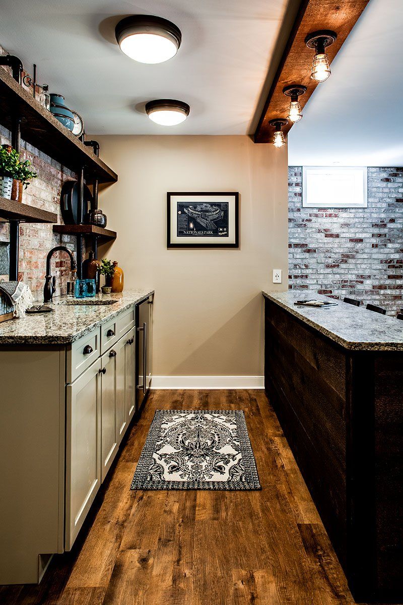 There is a picture on the wall above the counter in the kitchen.