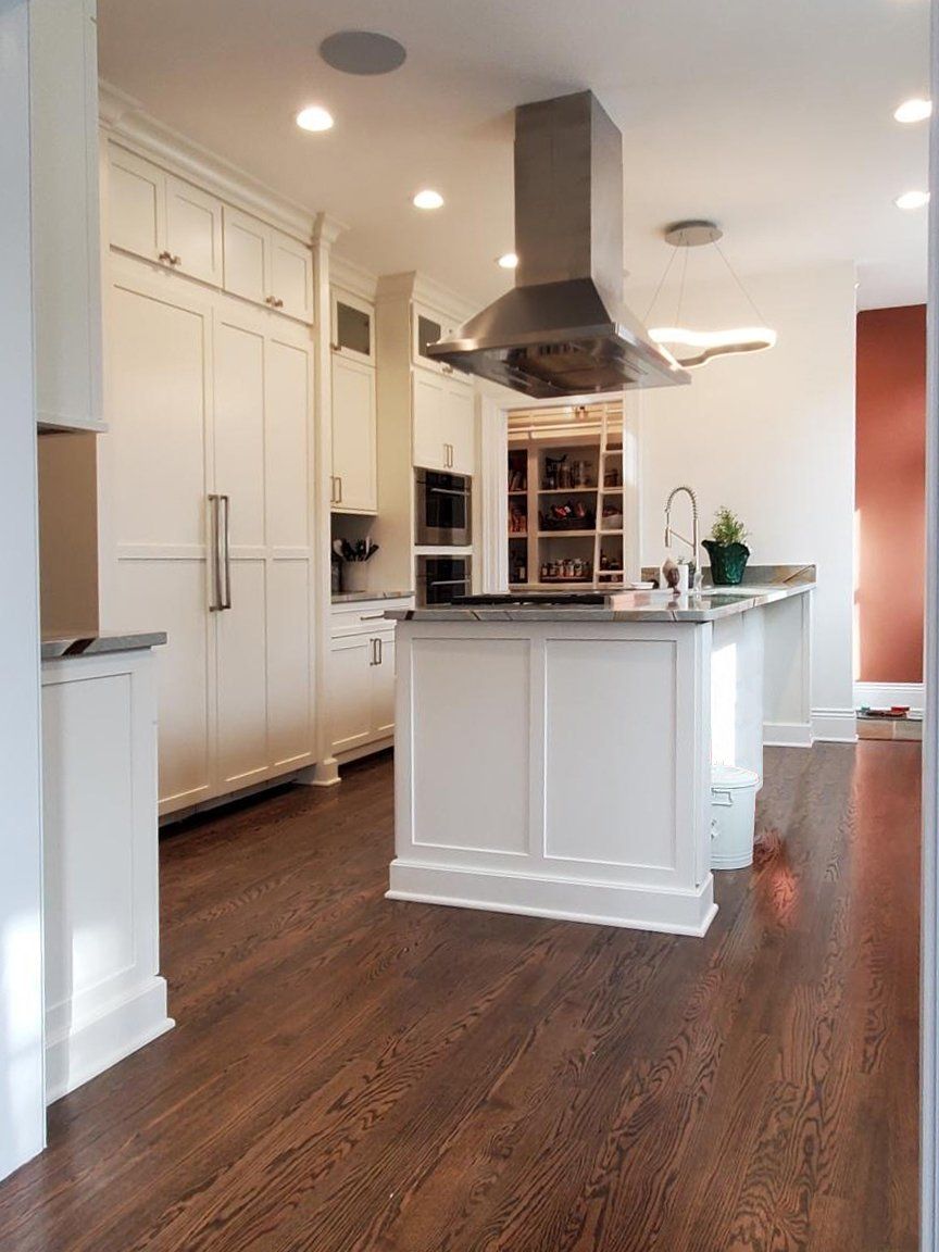 A kitchen with white cabinets and stainless steel appliances