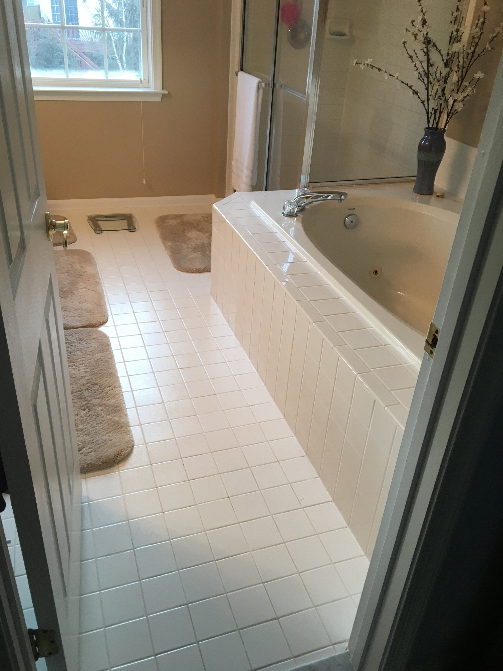 A bathroom with a tub and a window.