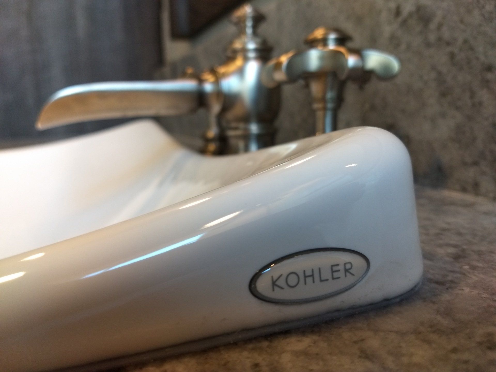 A white sink with a kohler logo on it