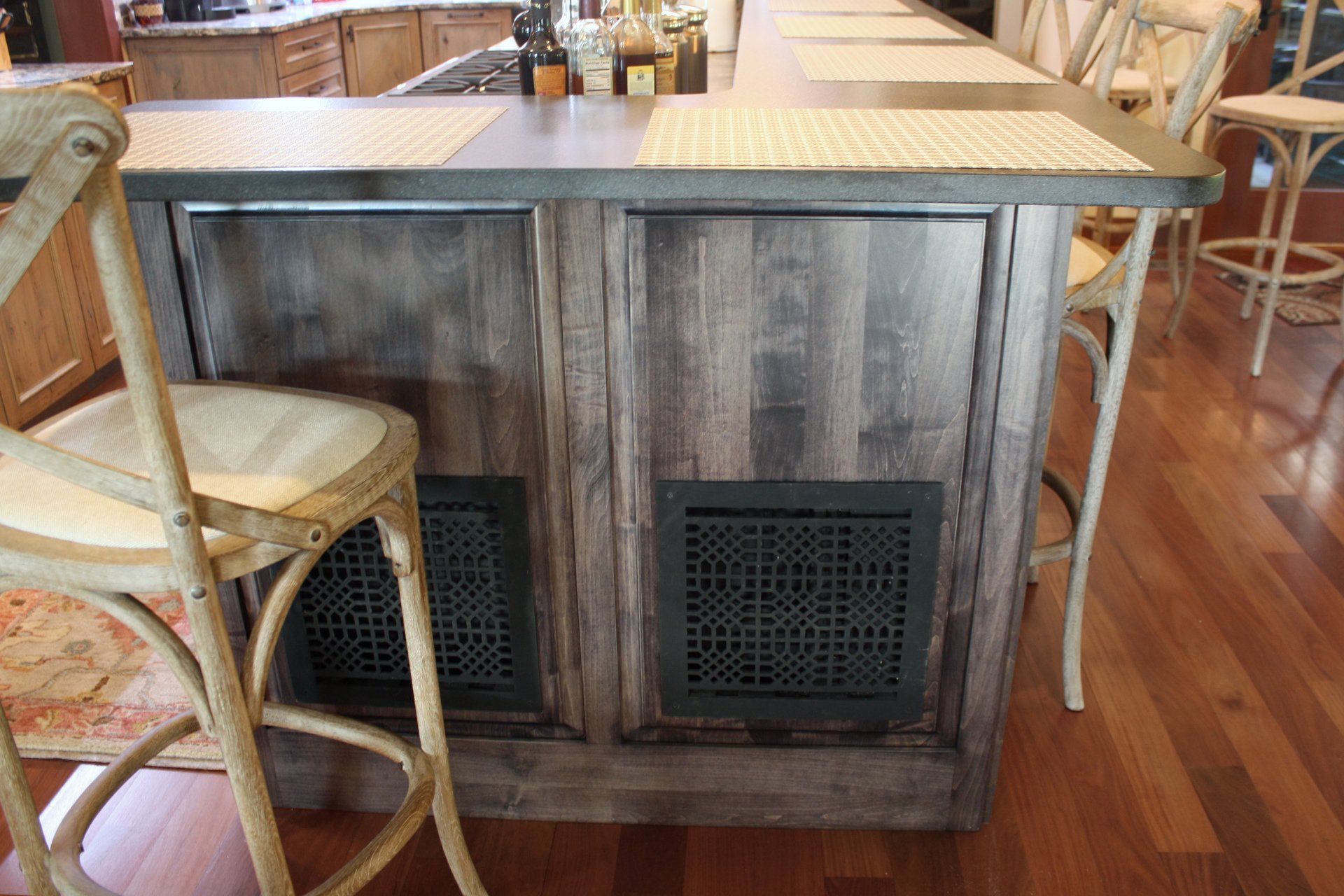 A chair is sitting next to a wooden counter in a kitchen.