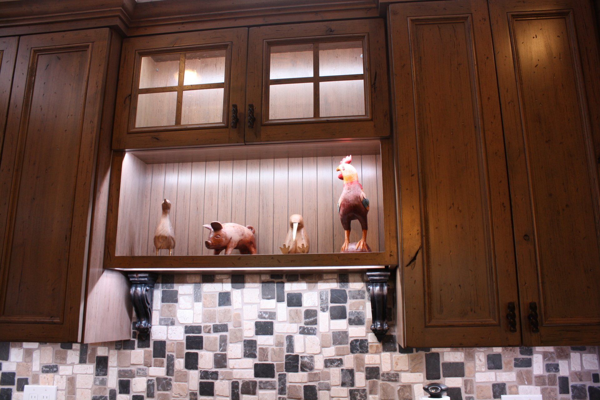 A kitchen with wooden cabinets and a tiled counter top