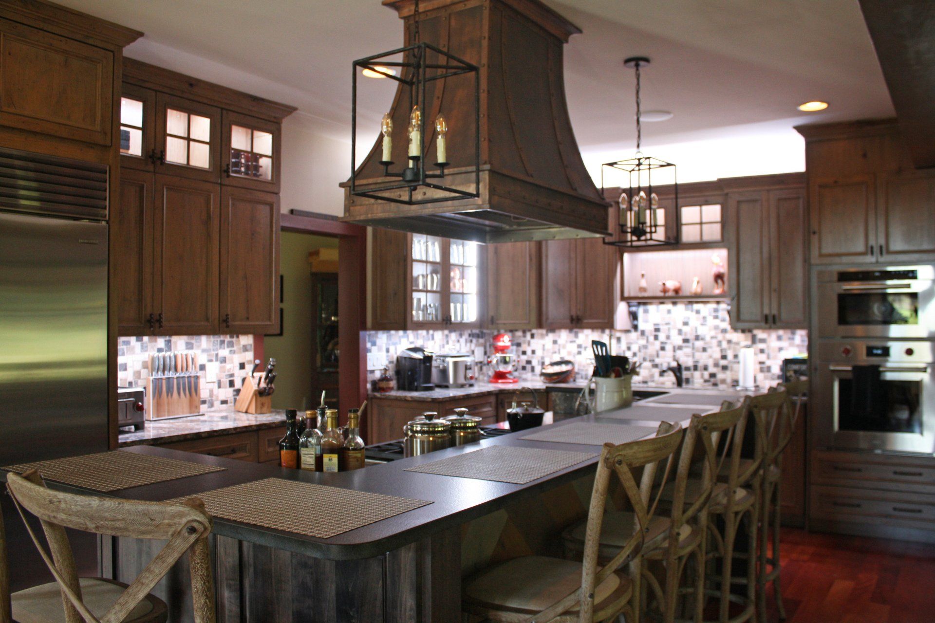 A kitchen with stainless steel appliances and wooden cabinets