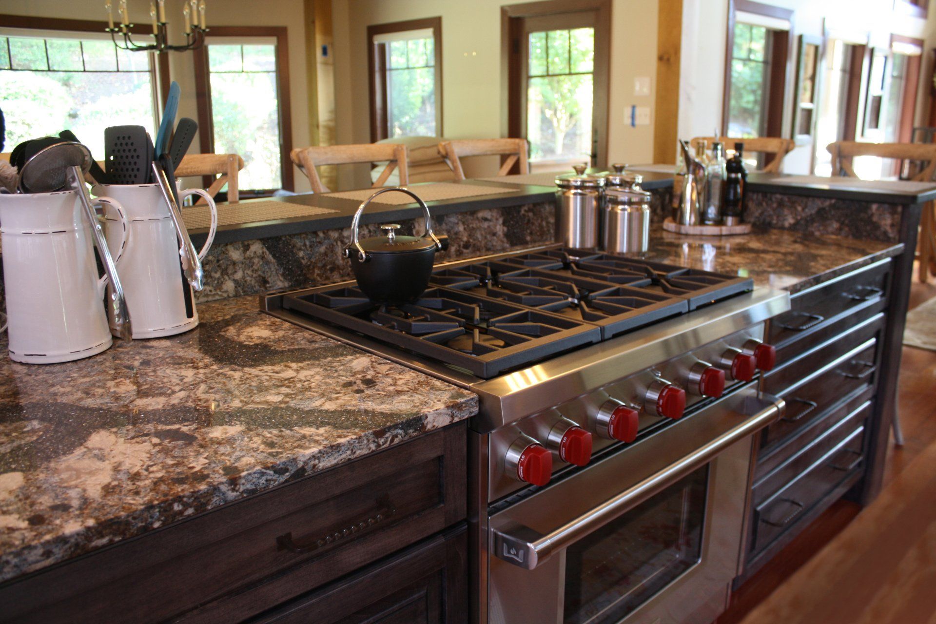 A kitchen with a stove top oven and granite counter tops