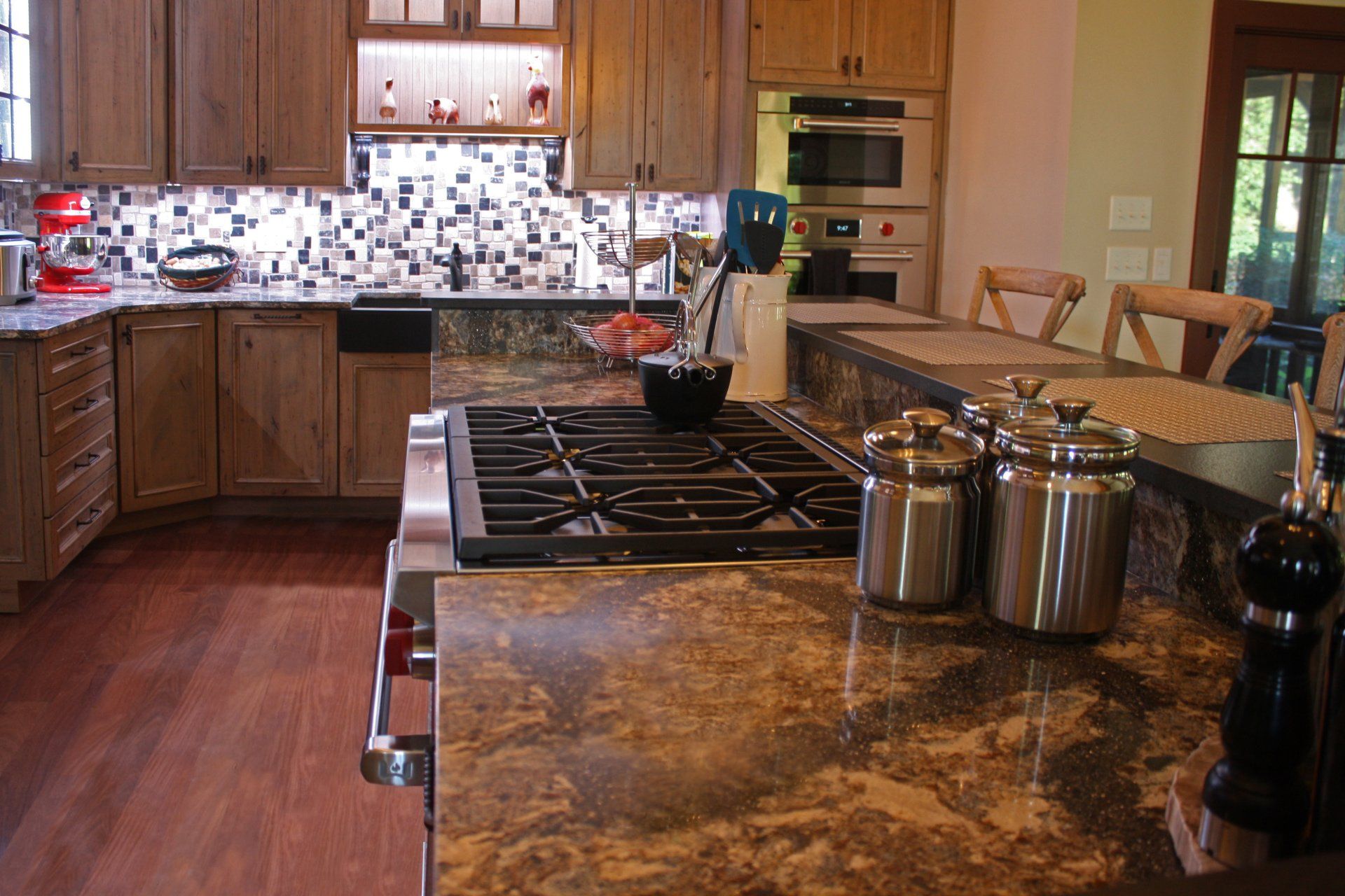 A kitchen with a stove top oven , pots and pans on the counter.