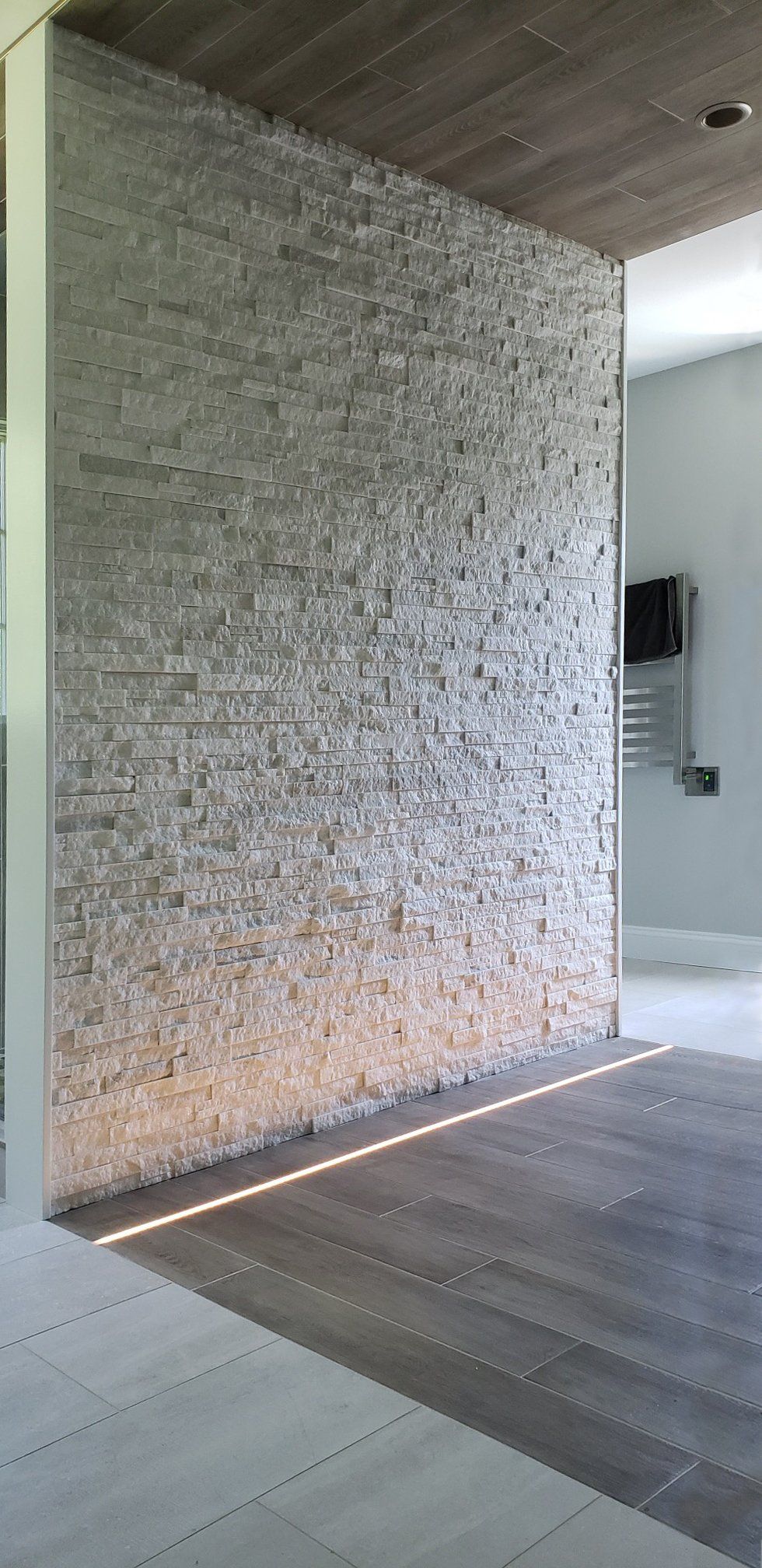 A room with a brick wall and a wooden floor.