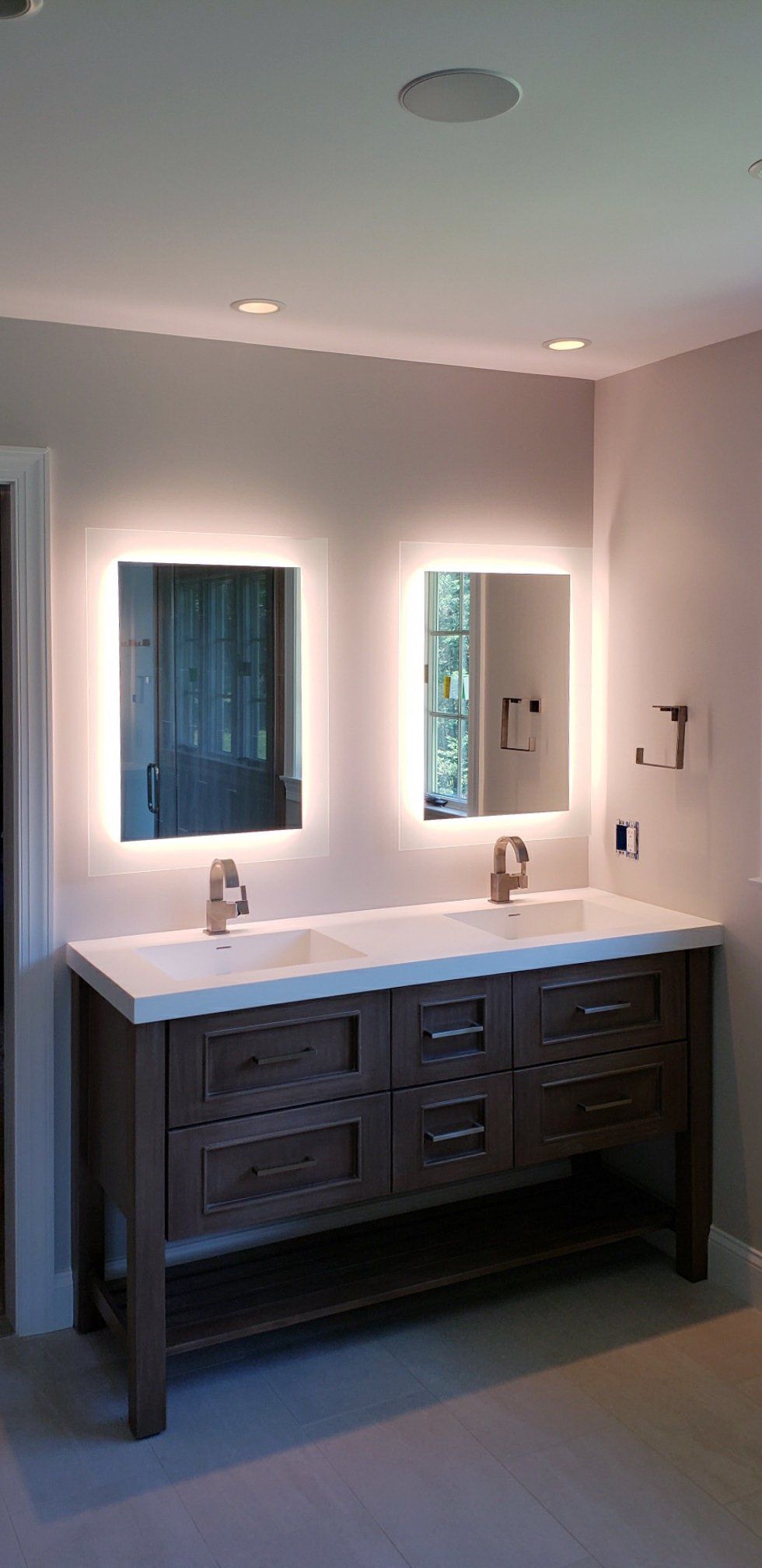 A bathroom with two sinks and two mirrors.