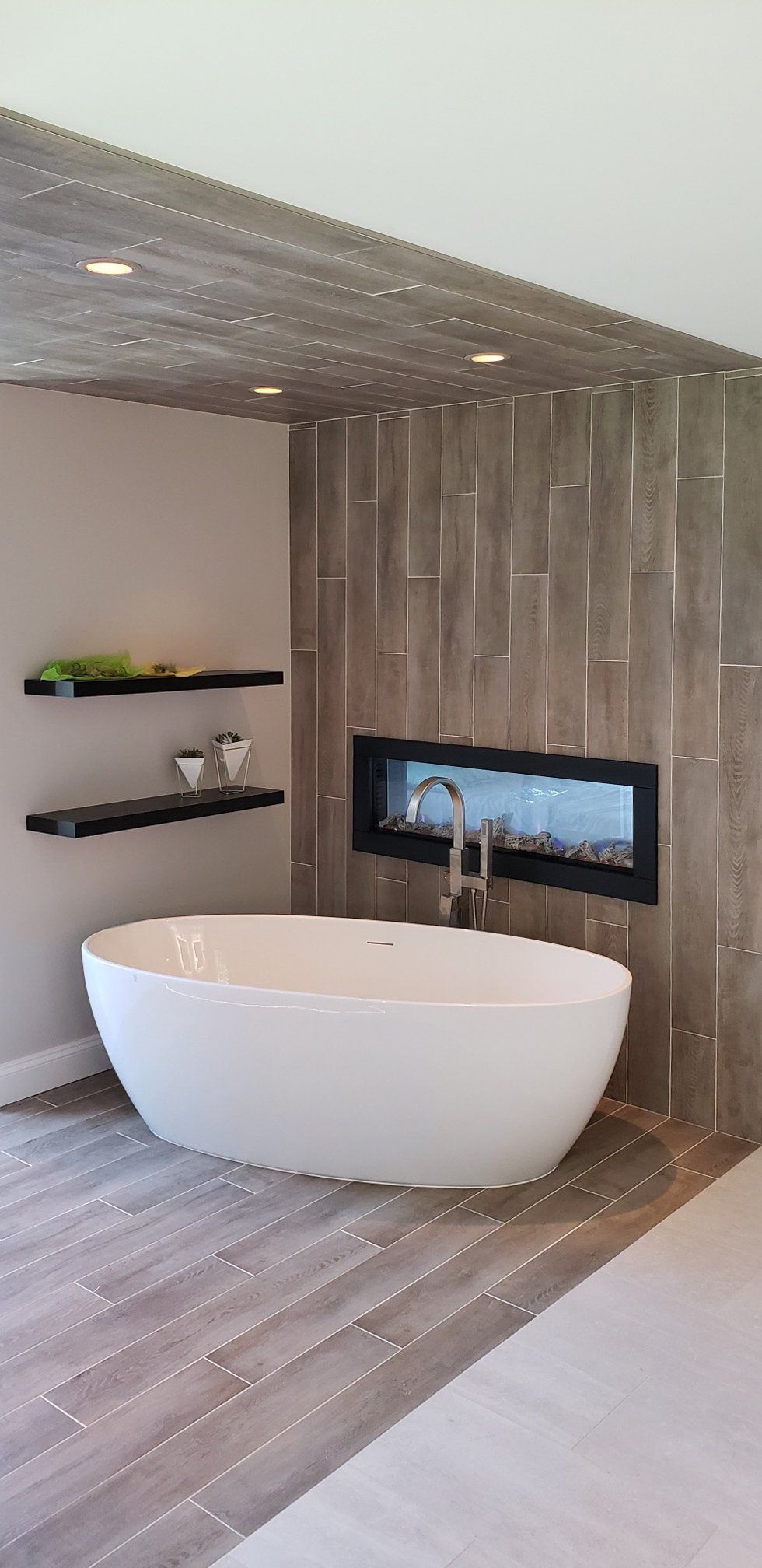 There is a bathtub in the middle of the bathroom.