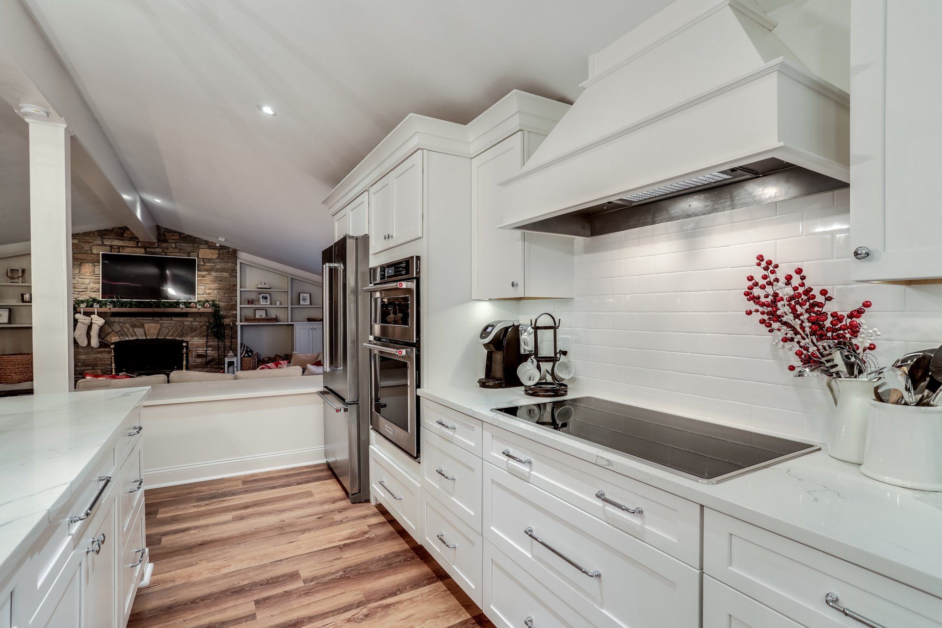 A kitchen with white cabinets and stainless steel appliances