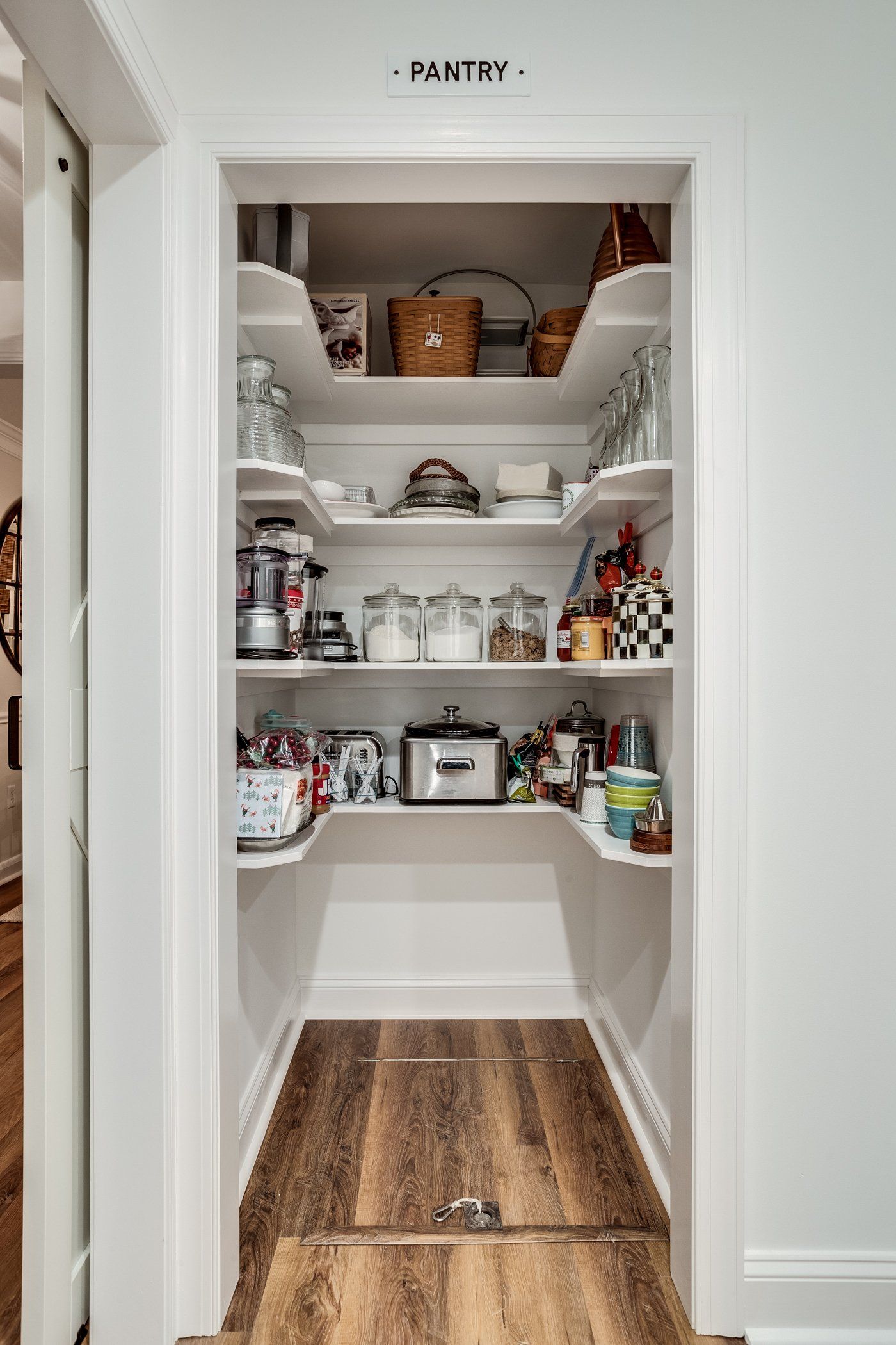 A pantry filled with lots of food and appliances.
