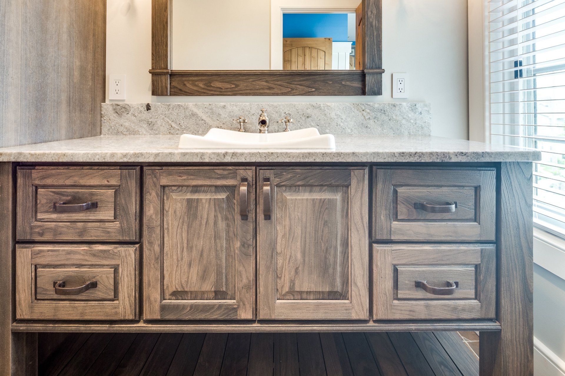 A bathroom vanity with a sink and a mirror.