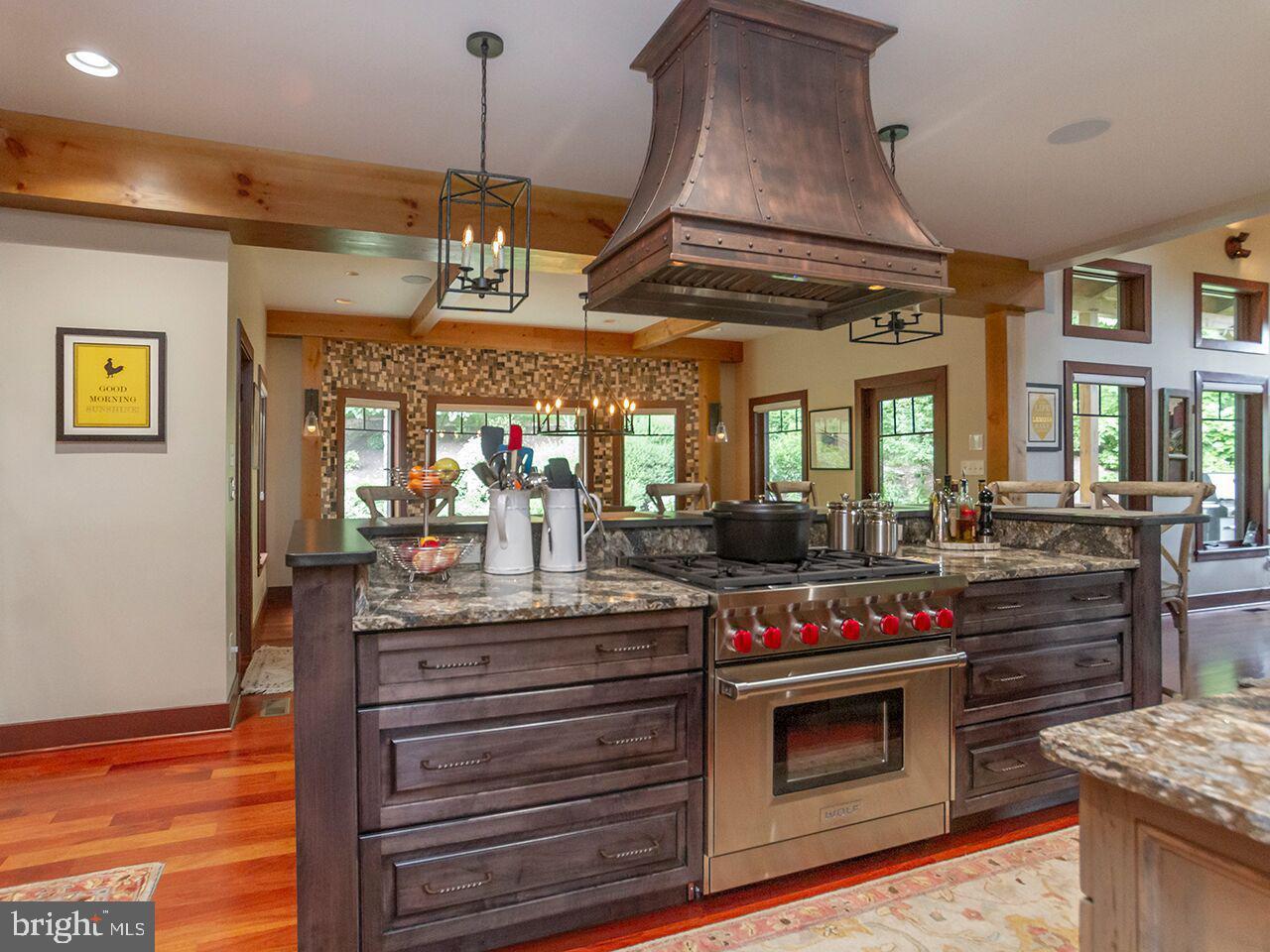A kitchen with stainless steel appliances and a large island.