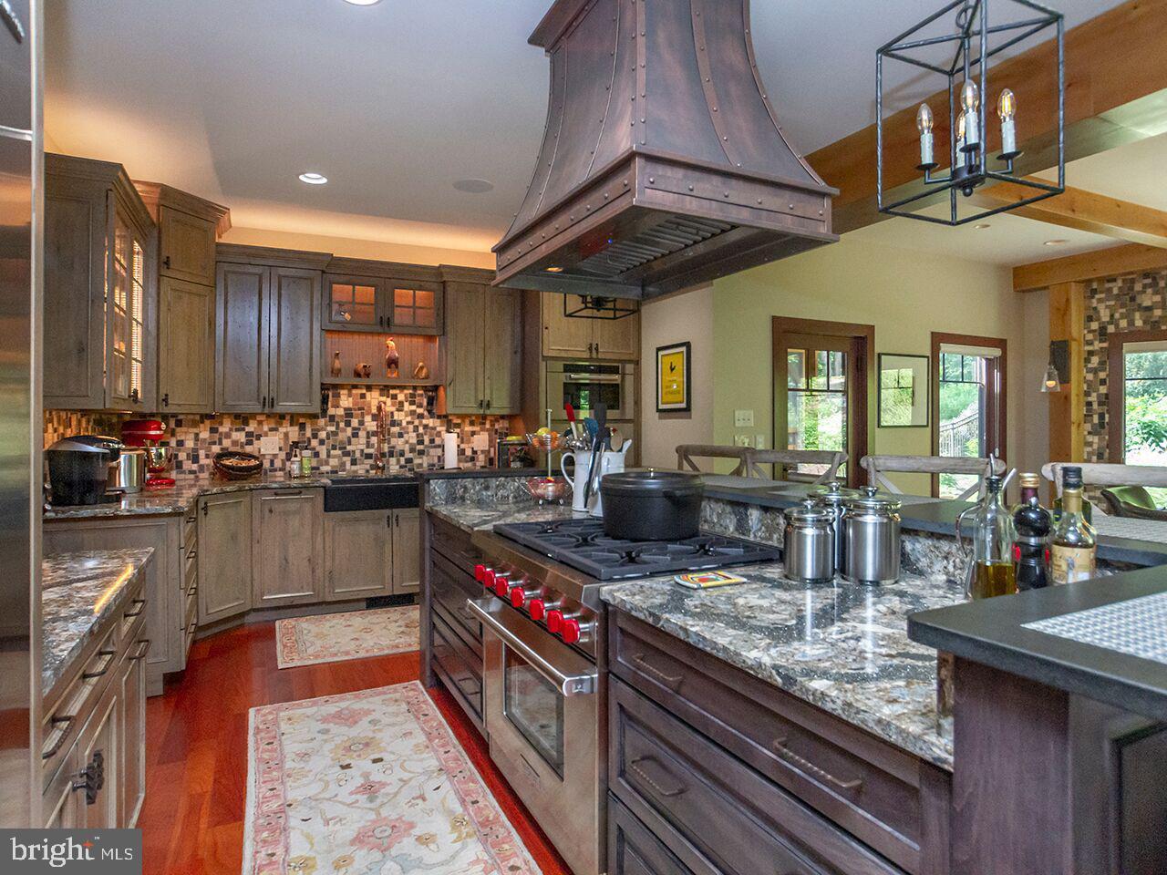 A kitchen with stainless steel appliances and granite counter tops.