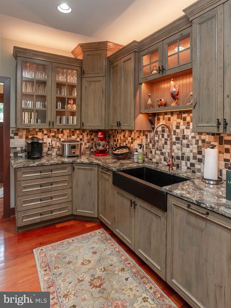 A kitchen with wooden cabinets and granite counter tops