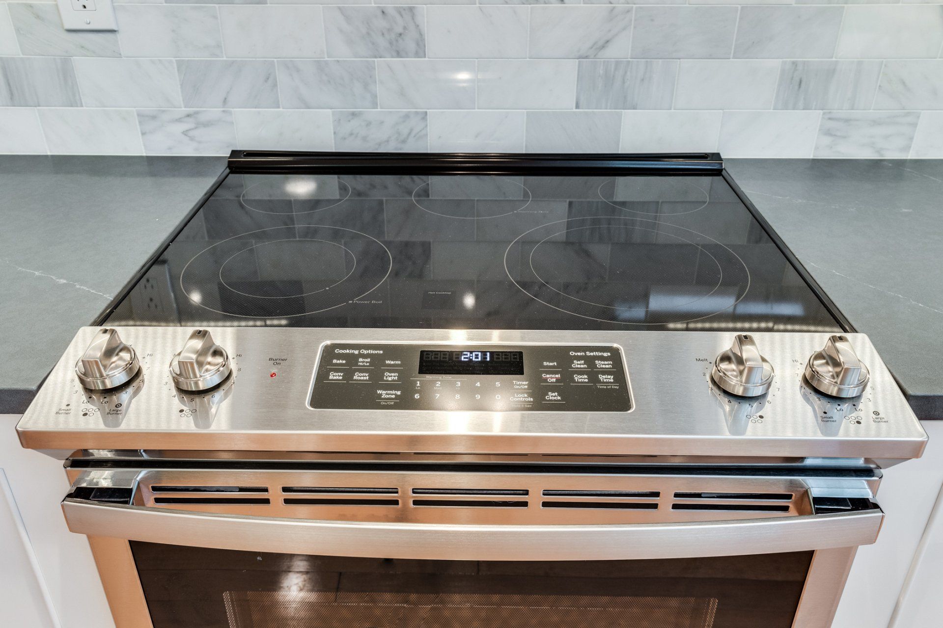 A stainless steel stove top oven is sitting on top of a counter.