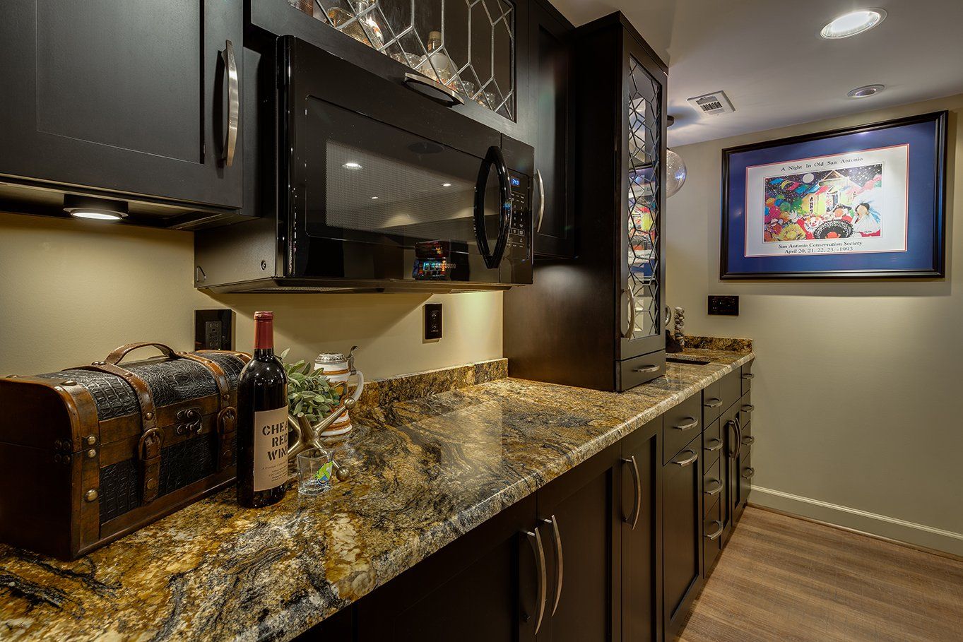 A bottle of wine is sitting on a counter in a kitchen.