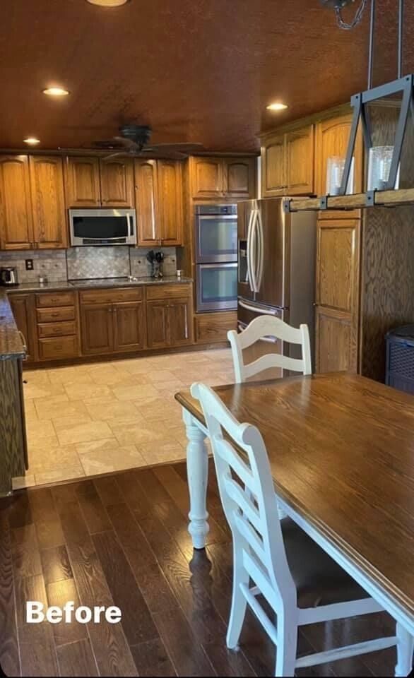 A kitchen with a table and chairs before being remodeled.