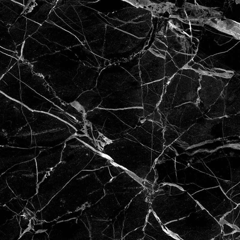 A close up of a black marble texture with white veins.