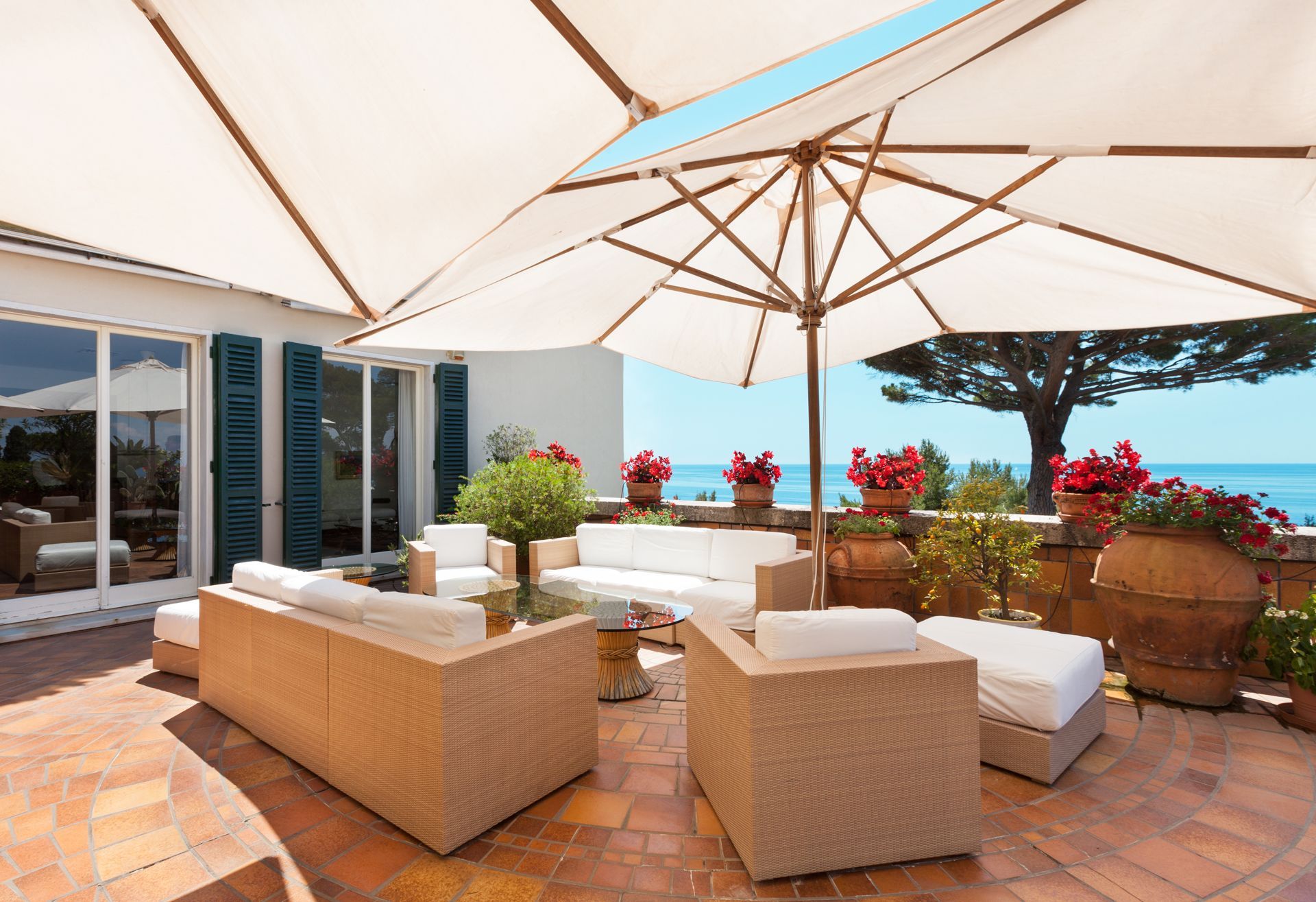 Patio With Wicker Furniture and Umbrellas