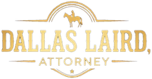 Gold logo for Dallas Laird, Attorney, featuring a silhouette of a person on a horse inside an arched frame.