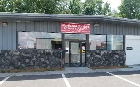Northland Comfort heating and cooling business exterior with a stone facade and large windows.