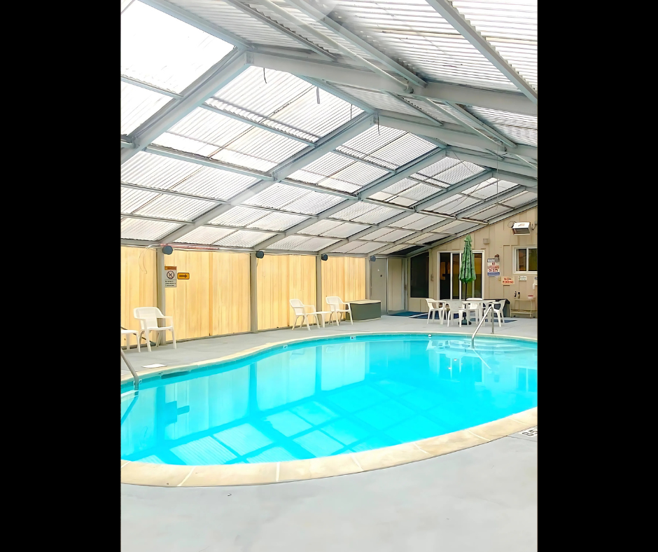 An in-ground pool with a roof overhead.