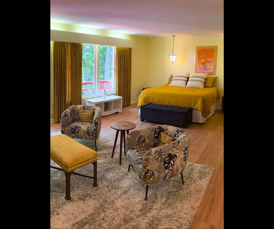 A hotel room with a bed , couch , table and chairs.