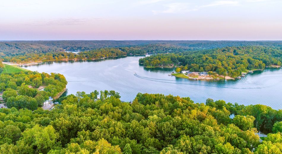 An aerial view of a lake surrounded by trees.