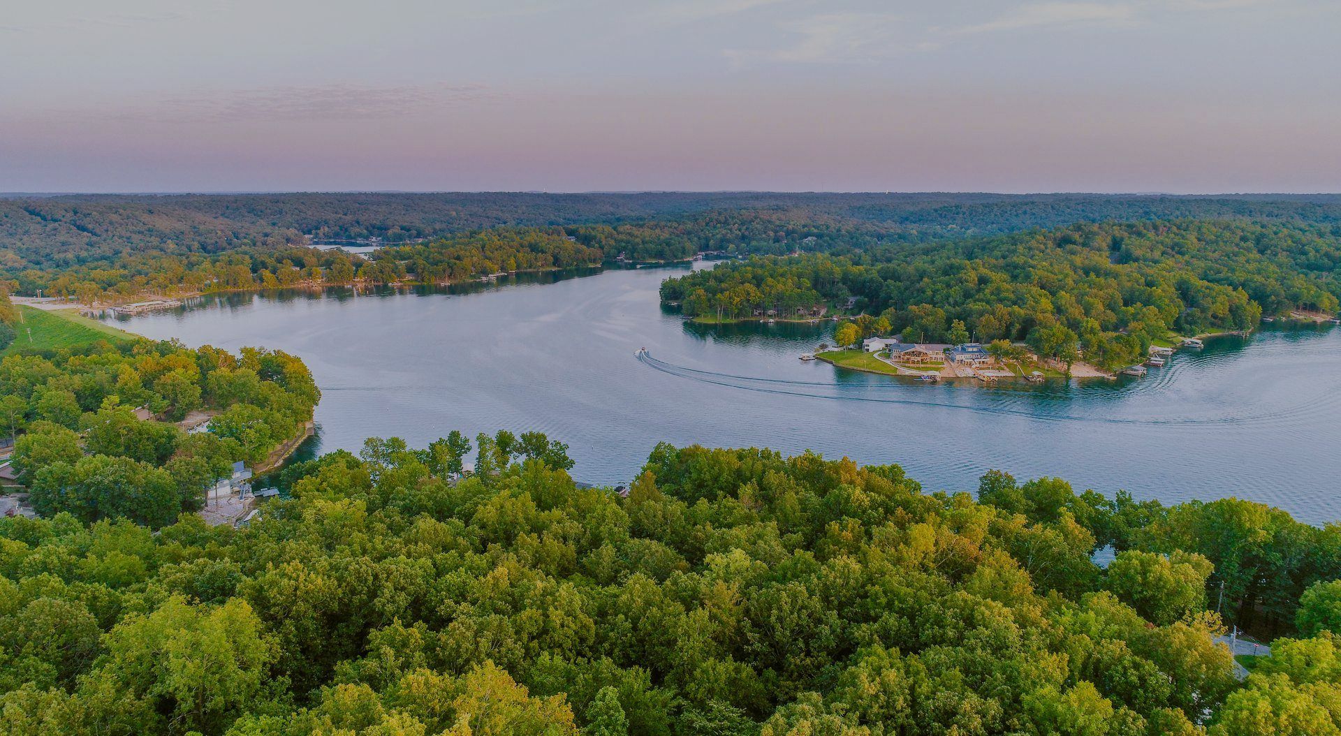 An aerial view of a lake surrounded by trees.