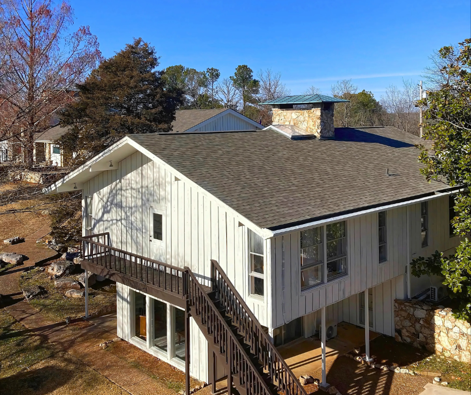 Exterior of a two-story guest house with a metal staircase.